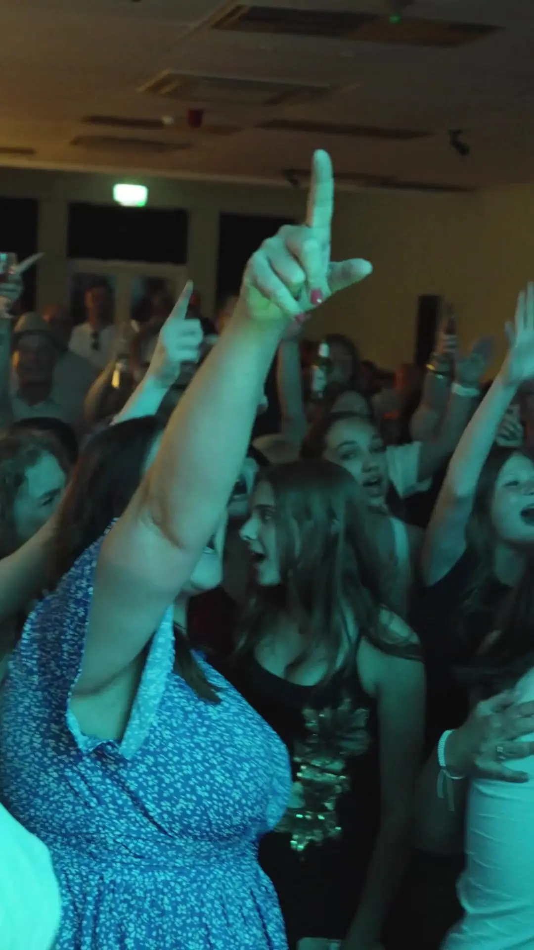 Close-up of fans singing along to Don't Look Back in Anger