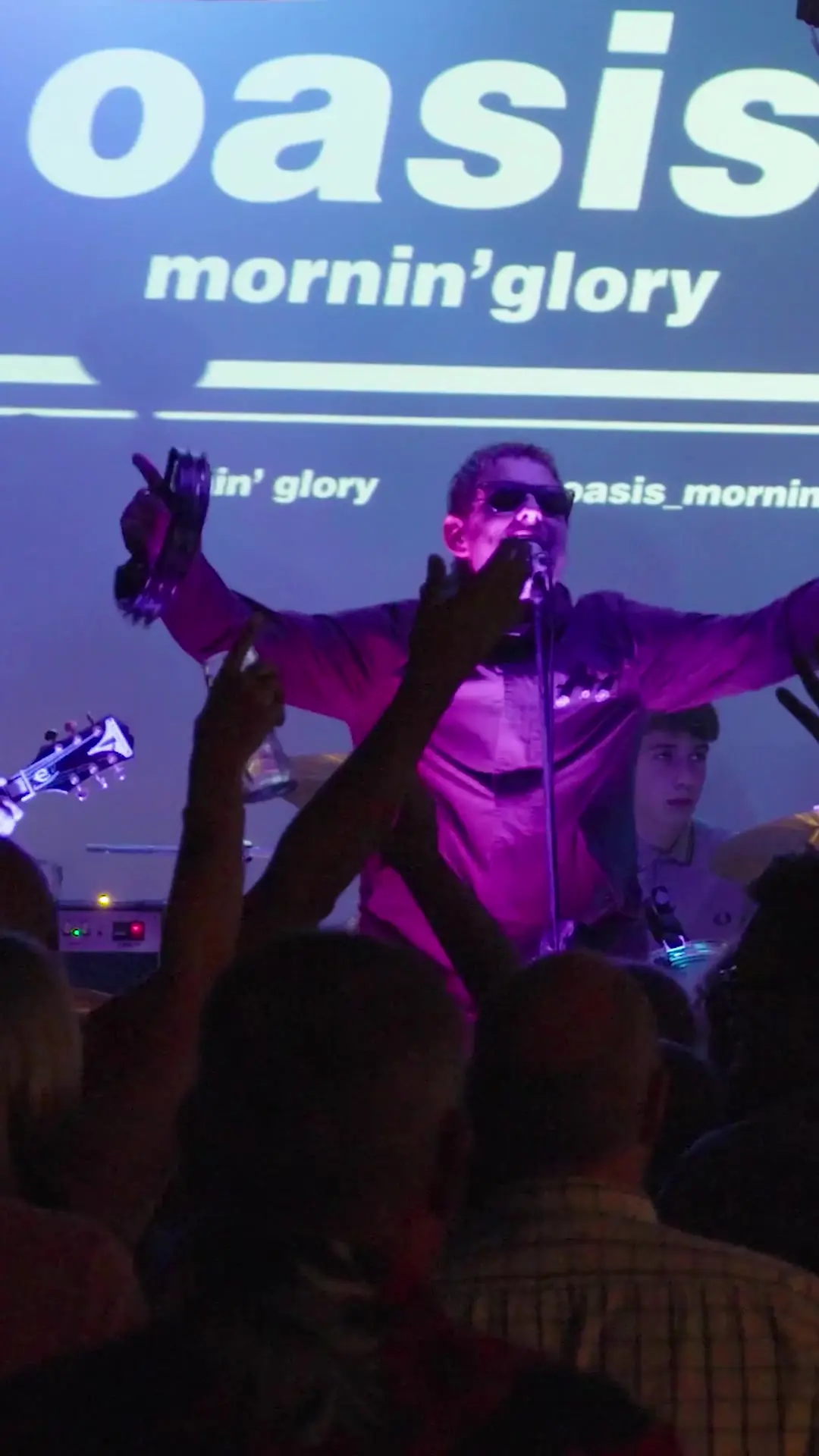 Frontman and audience with arms raised during Stand By Me